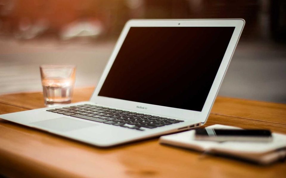 A tidy desk with a laptop open on it
