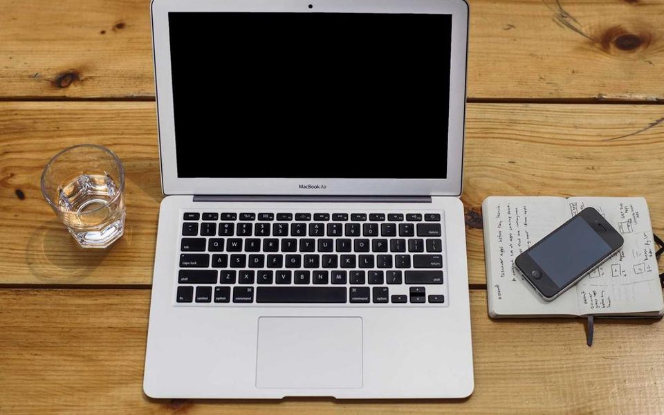 A laptop and a notebook seen from above